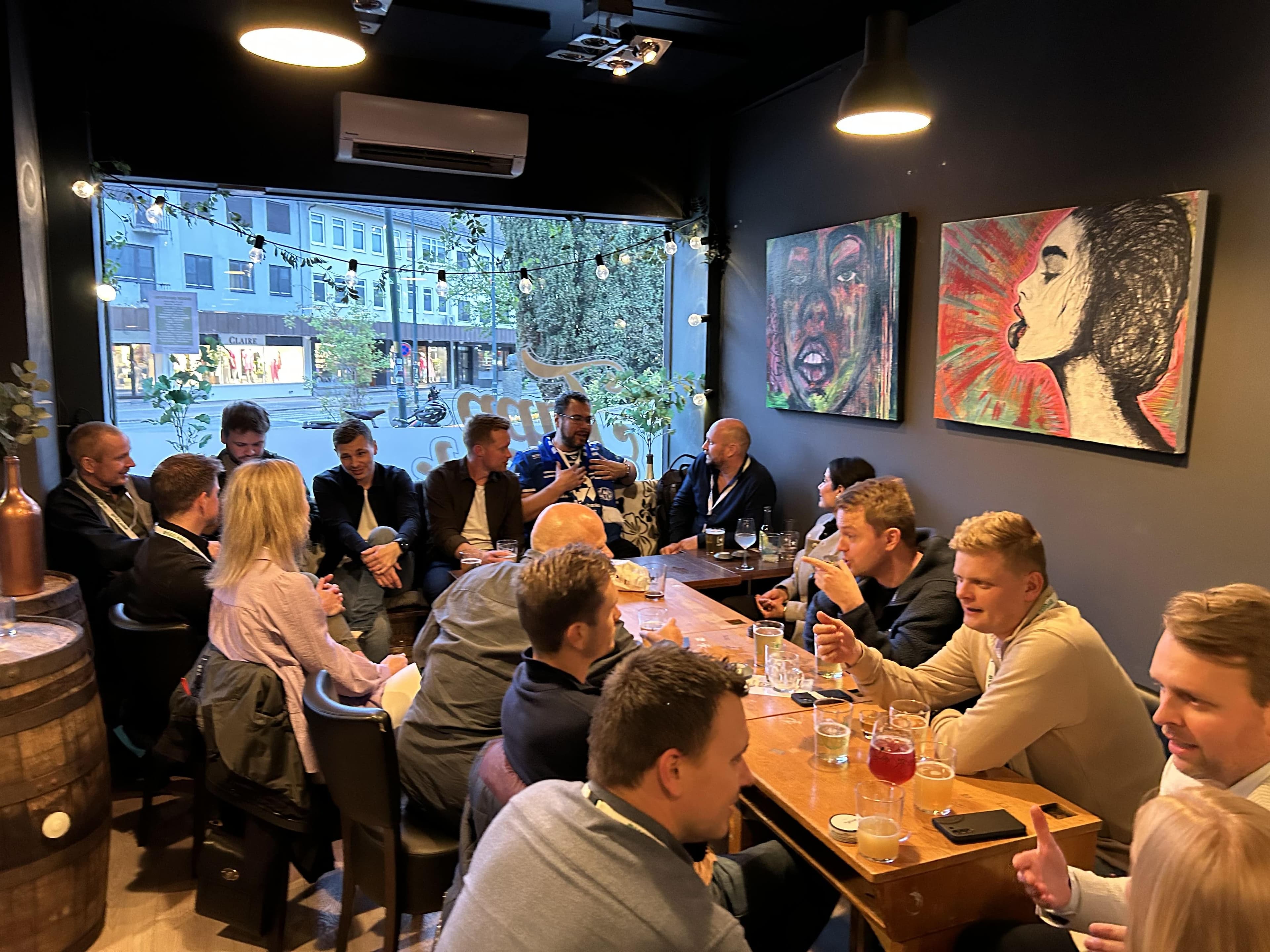 Participants in conversation around tables at a gathering