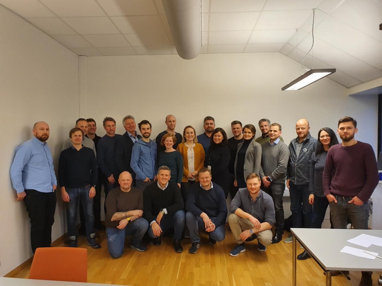A group of participants gathered in a meeting room